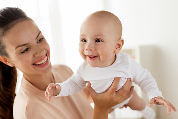 Image showing happy mother playing with little baby boy at home