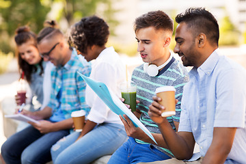 Image showing students with notebook and takeaway drinks