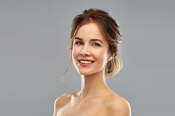 Image showing smiling young woman over grey background