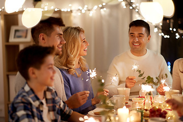 Image showing family with sparklers having tea party at home