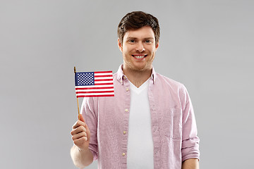 Image showing happy man with american flag over grey background