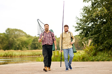 Image showing friends with fishing rods and net at lake or river