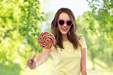 Image showing teenage girl in sunglasses with lollipop