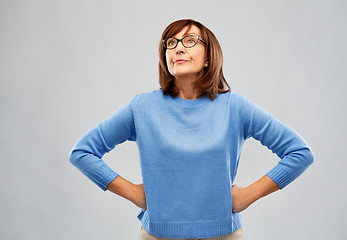 Image showing displeased senior woman in glasses over grey