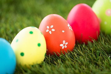 Image showing row of colored easter eggs on artificial grass