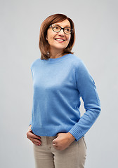 Image showing portrait of senior woman in glasses over grey