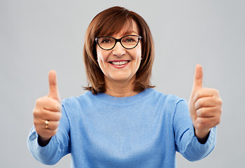 Image showing portrait of senior woman showing thumbs up