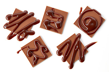 Image showing chocolate squares decorated with chocolate sauce