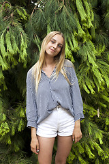 Image showing Beautiful young woman wearing elegant clothes standing in the fo