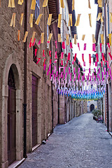 Image showing Colorful paper flags over italian street.