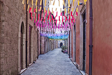 Image showing Colorful paper flags over italian street.