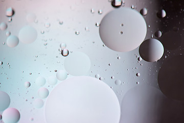 Image showing Defocused pastel and dark colored abstract background picture made with oil, water and soap