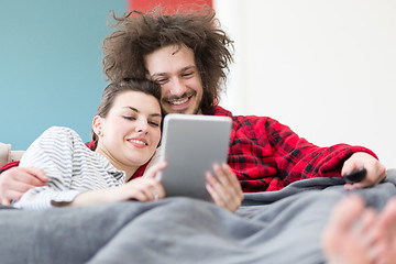 Image showing couple relaxing at  home with tablet computers