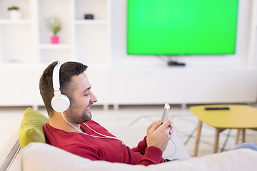 Image showing man enjoying music through headphones