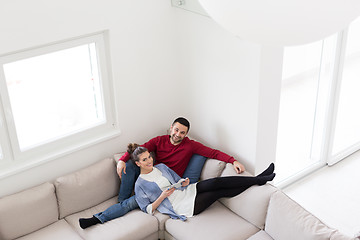 Image showing couple relaxing at  home with tablet computers