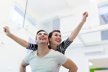 Image showing handsome man piggybacking his girlfriend