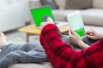 Image showing couple relaxing at  home with tablet computers