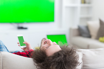 Image showing young man in bathrobe enjoying free time