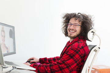 Image showing graphic designer in bathrobe working at home