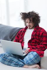 Image showing man freelancer in bathrobe working from home