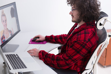 Image showing graphic designer in bathrobe working at home