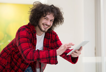 Image showing young freelancer using tablet computer