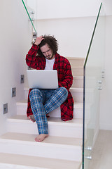 Image showing freelancer in bathrobe working from home