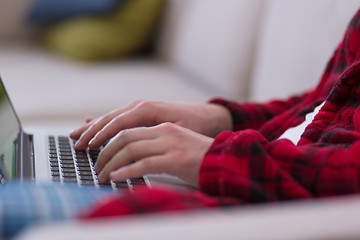 Image showing man freelancer in bathrobe working from home