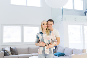 Image showing couple hugging in their new home