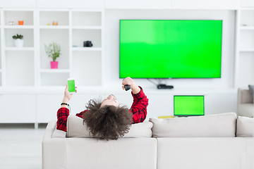 Image showing young man in bathrobe enjoying free time