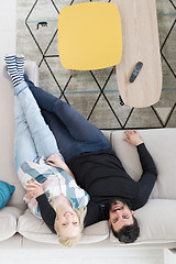 Image showing Young couple on the sofa watching television top view