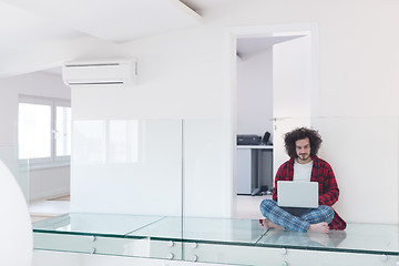 Image showing young freelancer in bathrobe working from home