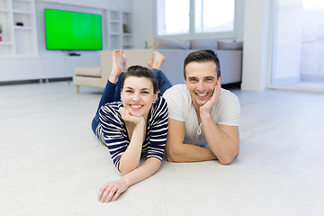 Image showing couple lying on the floor at home