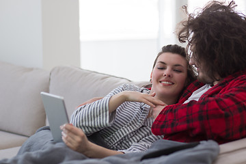 Image showing couple relaxing at  home with tablet computers