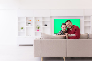 Image showing couple hugging and relaxing on sofa