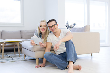 Image showing couple relaxing at  home with tablet computers