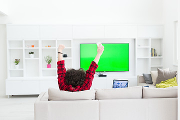 Image showing young man in bathrobe enjoying free time