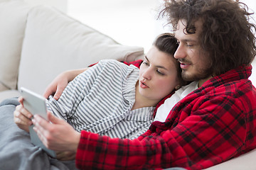 Image showing couple relaxing at  home with tablet computers