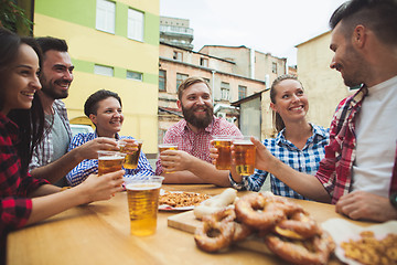 Image showing The group of friends enjoying drink at outdoor bar