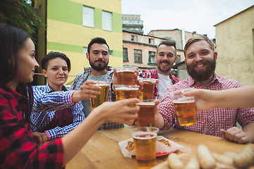 Image showing The group of friends enjoying drink at outdoor bar