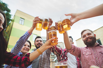 Image showing The group of friends enjoying drink at outdoor bar