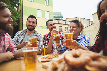 Image showing The group of friends enjoying drink at outdoor bar