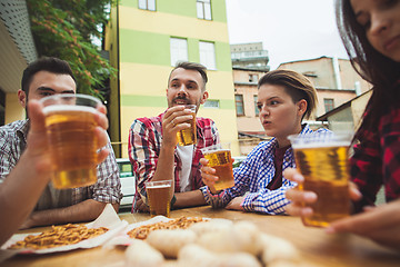 Image showing The group of friends enjoying drink at outdoor bar