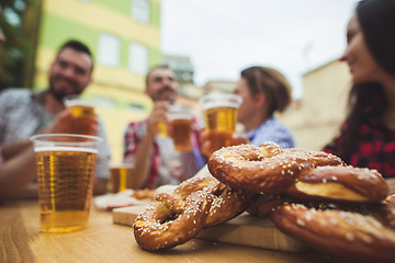 Image showing The group of friends enjoying drink at outdoor bar