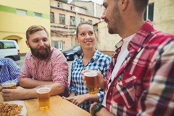 Image showing The group of friends enjoying drink at outdoor bar