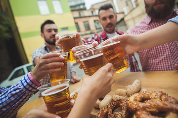 Image showing The group of friends enjoying drink at outdoor bar