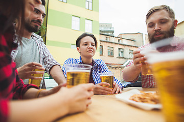 Image showing The group of friends enjoying drink at outdoor bar