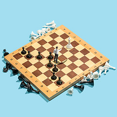 Image showing Business decision making concept. Miniature people : small businessman figure standing and walking on chessboard with chess pieces