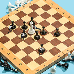 Image showing Business decision making concept. Miniature people : small businessman figure standing and walking on chessboard with chess pieces