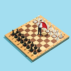 Image showing Business decision making concept. Miniature people : small businessman figure standing and walking on chessboard with chess pieces